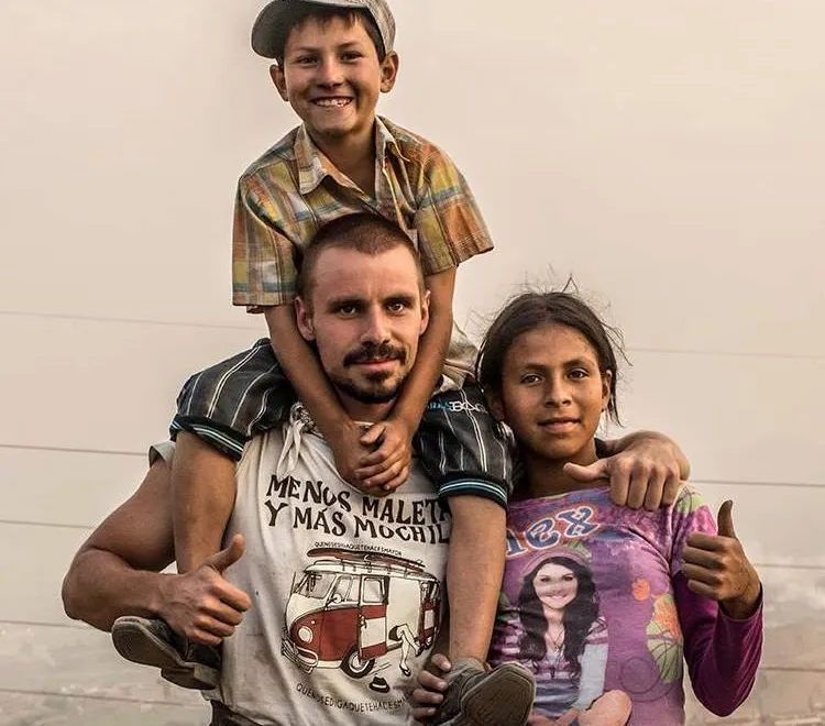 A volunteer with two children